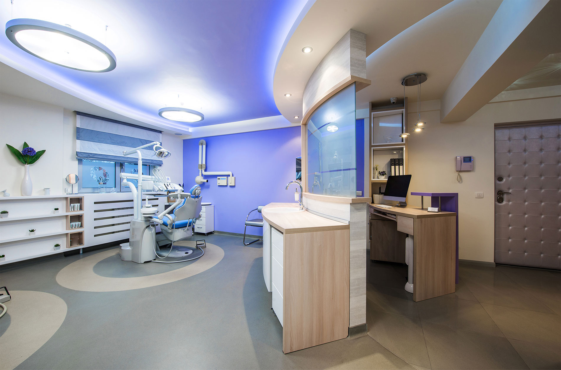 Modern dental treatment room with advanced equipment and calm blue lighting
